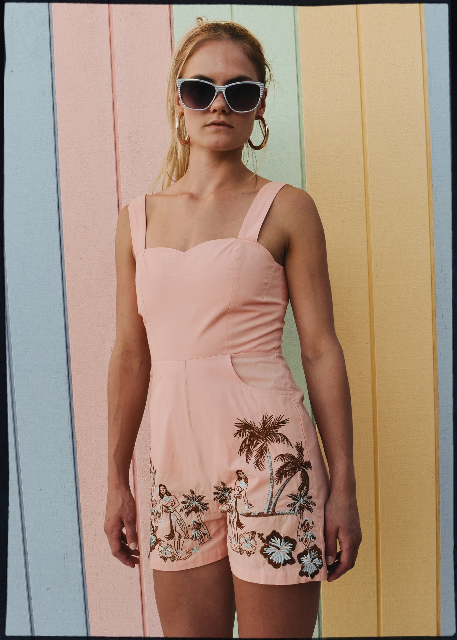 bohemian vintage retro style playsuit, beach suit bathing suit with shell buttons and pink material, hand embroidered with Hawaii tiki style hula gils and hibiscus flowers