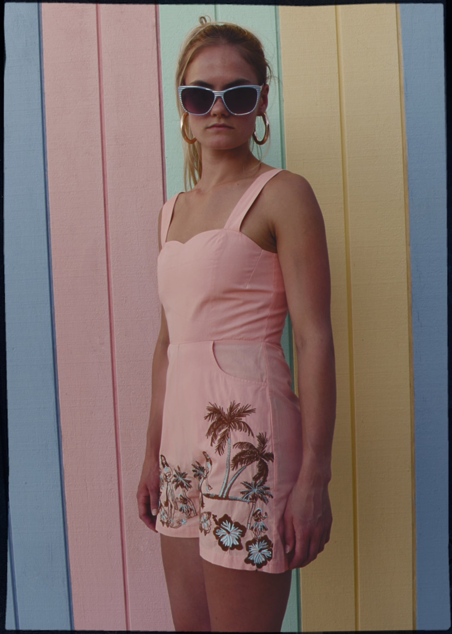 bohemian vintage retro style playsuit, beach suit bathing suit with shell buttons and pink material, hand embroidered with Hawaii tiki style hula gils and hibiscus flowers