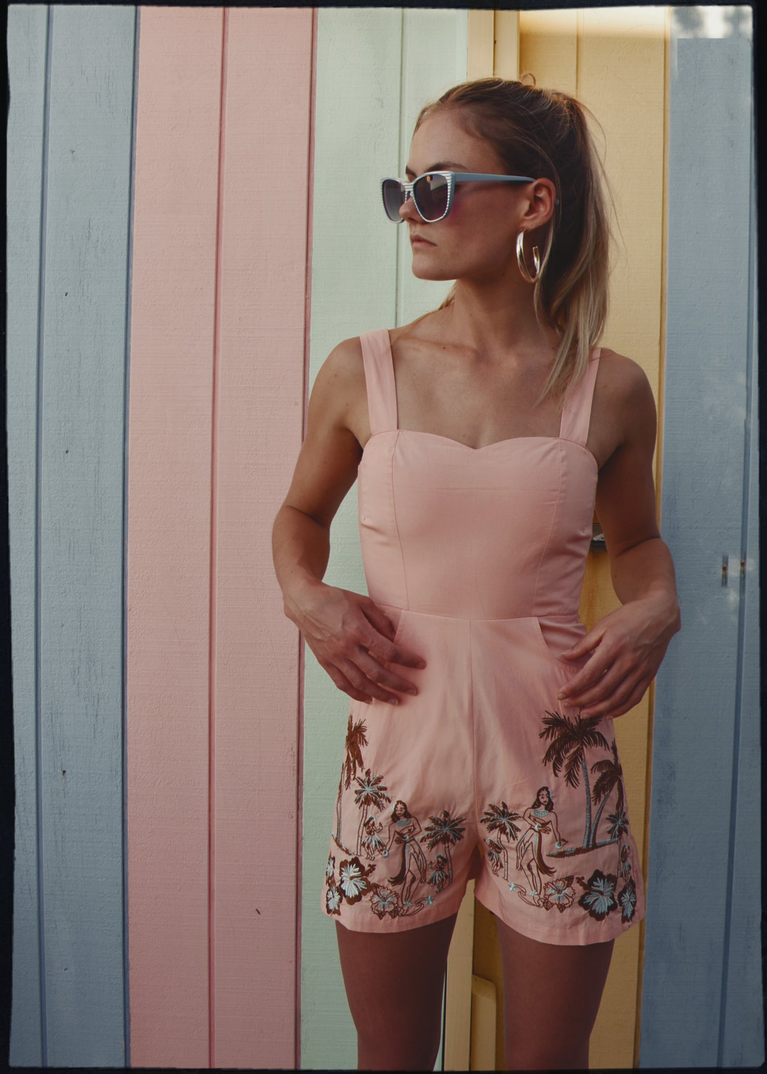 bohemian vintage retro style playsuit, beach suit bathing suit with shell buttons and pink material, hand embroidered with Hawaii tiki style hula gils and hibiscus flowers