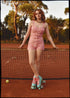 bohemian vintage retro style playsuit, beach suit bathing suit with shell buttons and printed pink material. Wearing roller skates on a clay tennis court