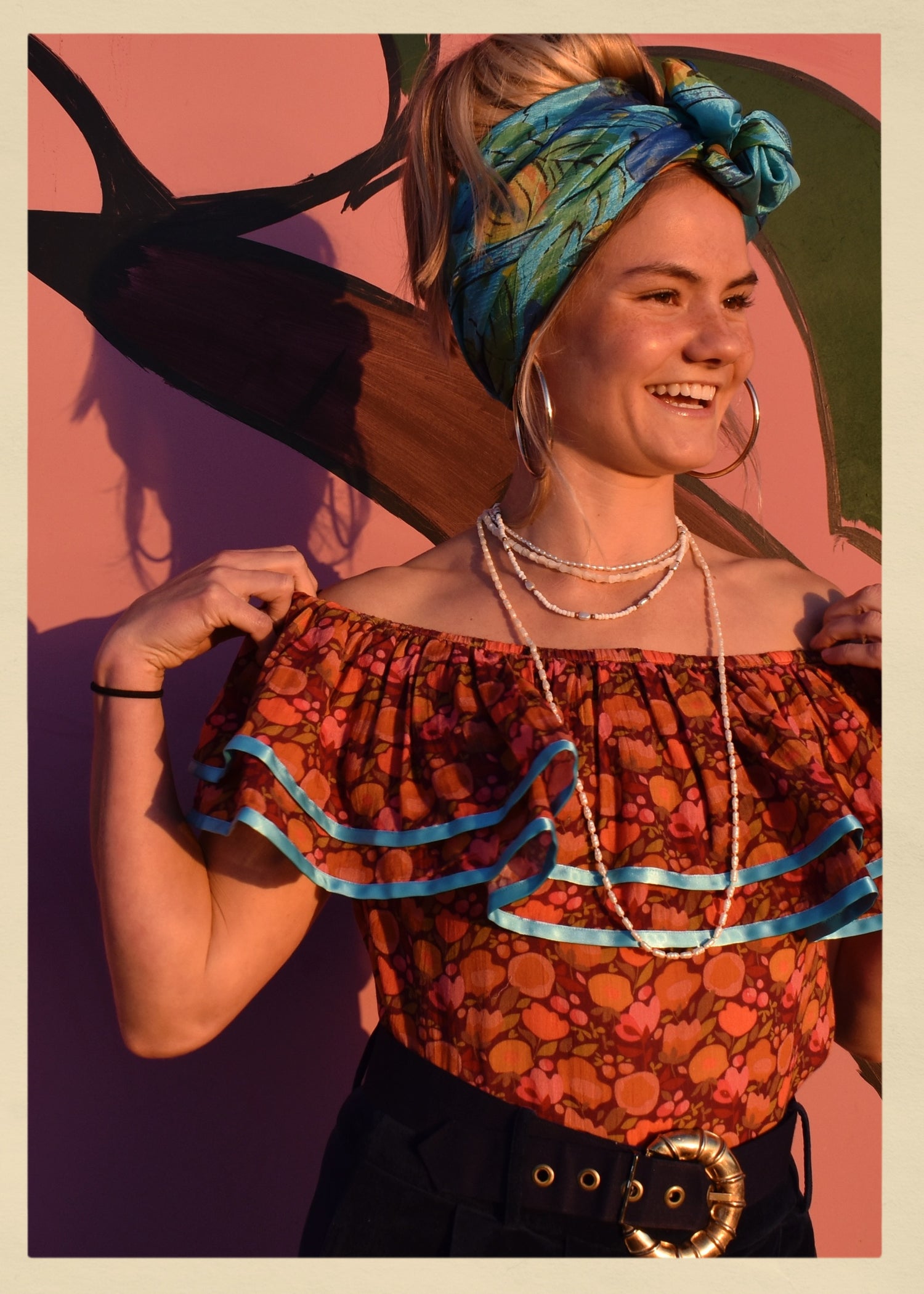 ruffle blouse top shirt warm autumn coloured printed cotton with blue satin ribbon trim. Calypso style salsa. The Outlaw Dame