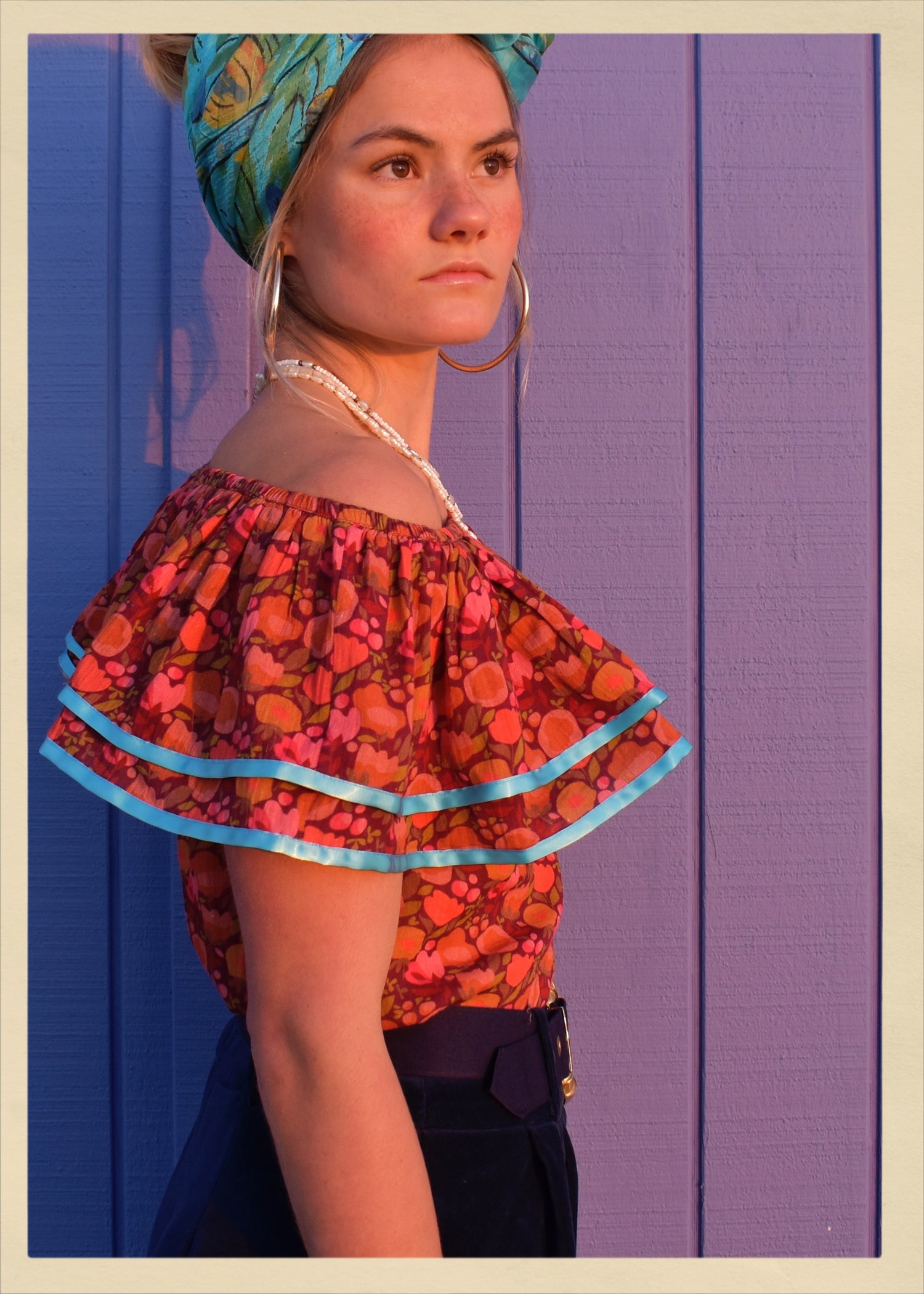 ruffle blouse top shirt warm autumn coloured printed cotton with blue satin ribbon trim. Calypso style salsa. The Outlaw Dame