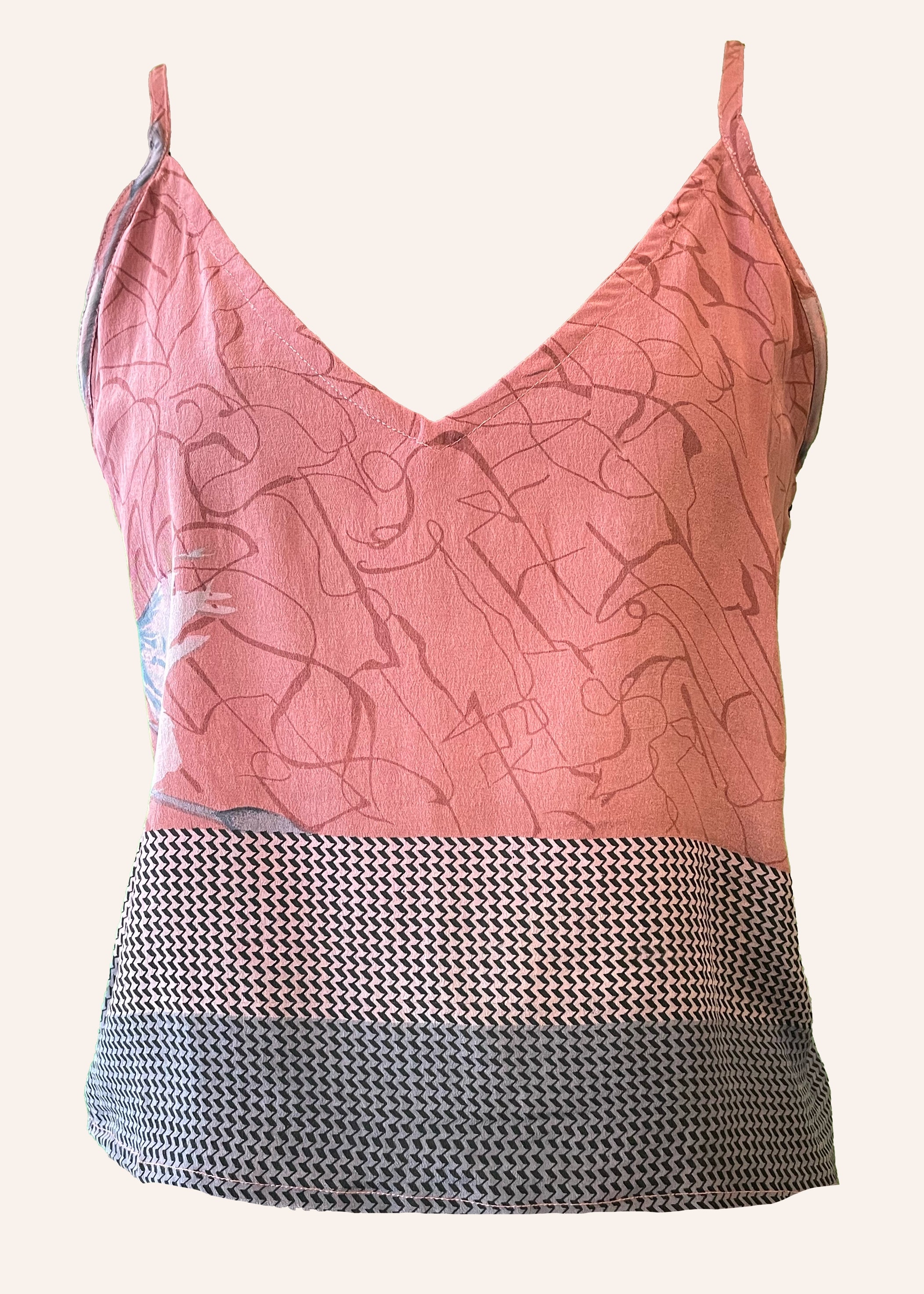 Pink patterned top with a black and white textured bottom on a white background