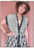 Woman wearing a bohemian style balloon sleeved patterned blouse made from vintage repurposed Indian silk crepe sari in front of a plain background