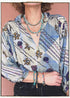 Woman wearing a bohemian style balloon sleeved patterned blouse made from vintage repurposed Indian silk crepe sari in front of a plain background