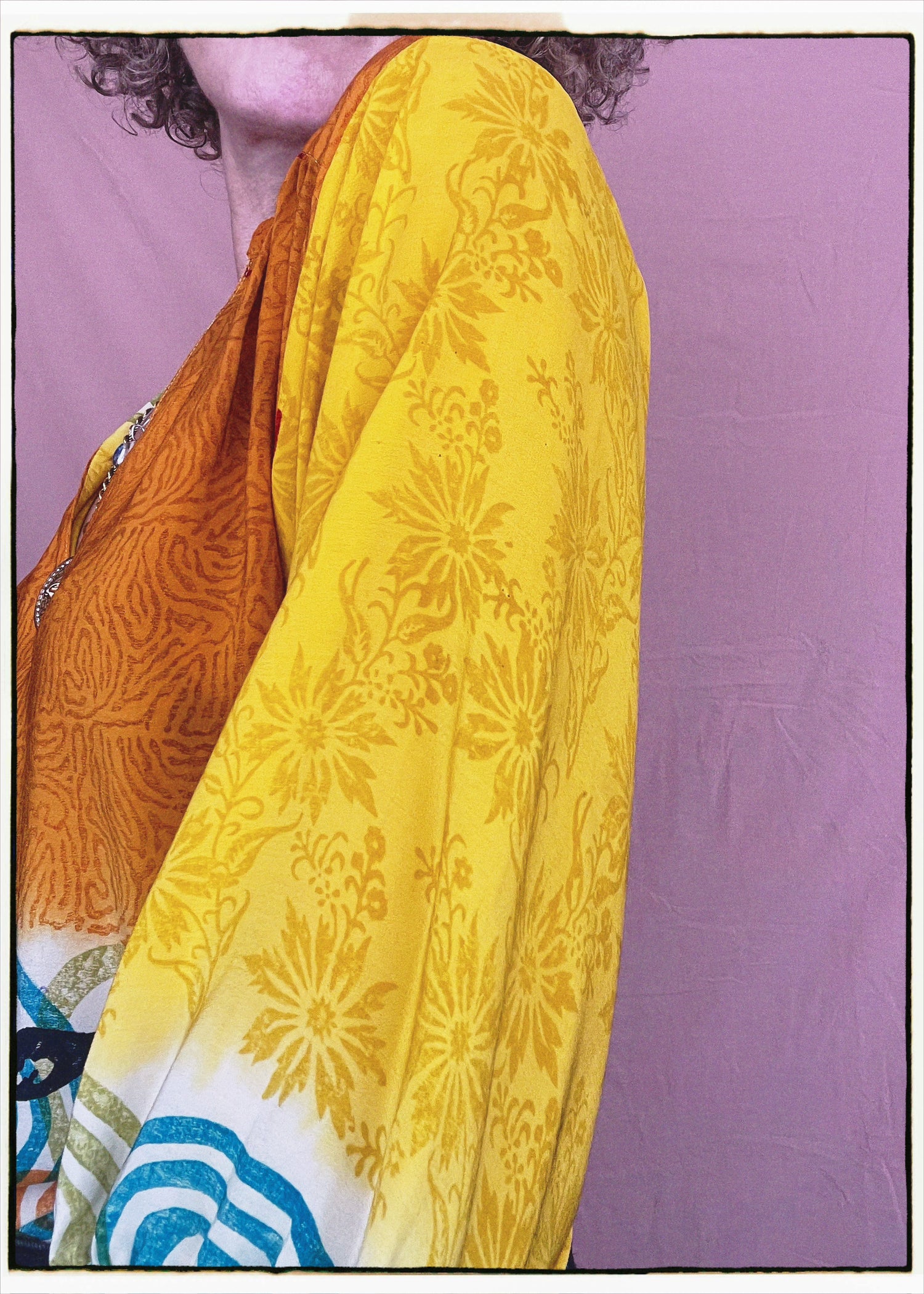 Woman wearing a bohemian style balloon sleeved blouse made from vintage repurposed Indian silk crepe sari in front of a plain background