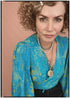 Woman wearing a bohemian style balloon sleeved patterned blouse made from vintage repurposed Indian silk crepe sari in front of a plain background