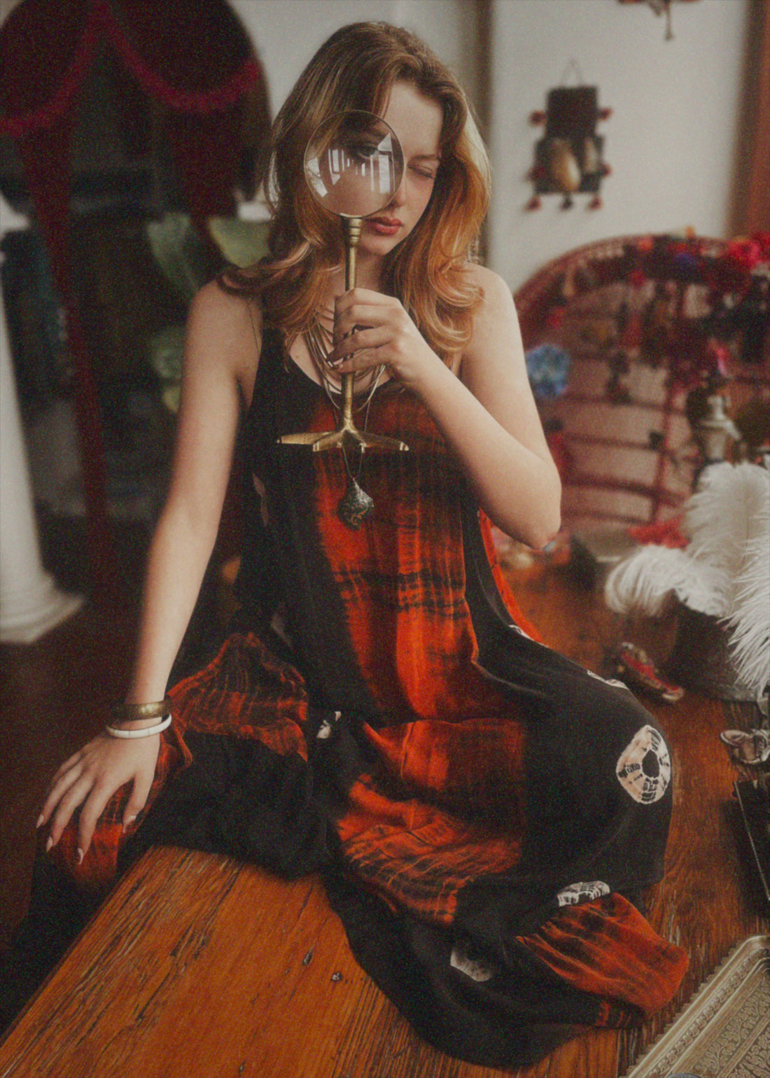 Woman in a plaid dress holding a wine glass in a vintage setting