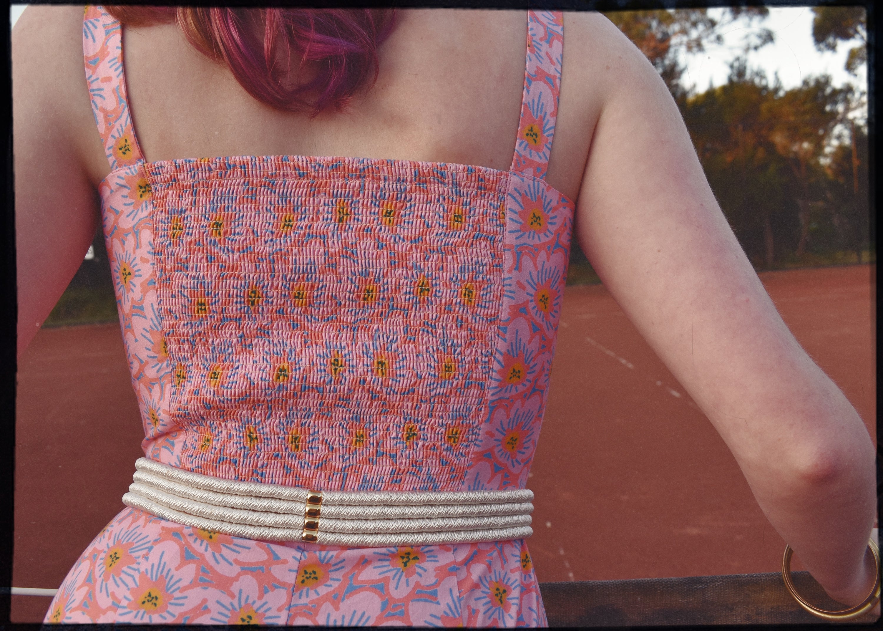 pink patterned retro style vintage playsuit, swimsuit, beach suit with shirred back and button up front