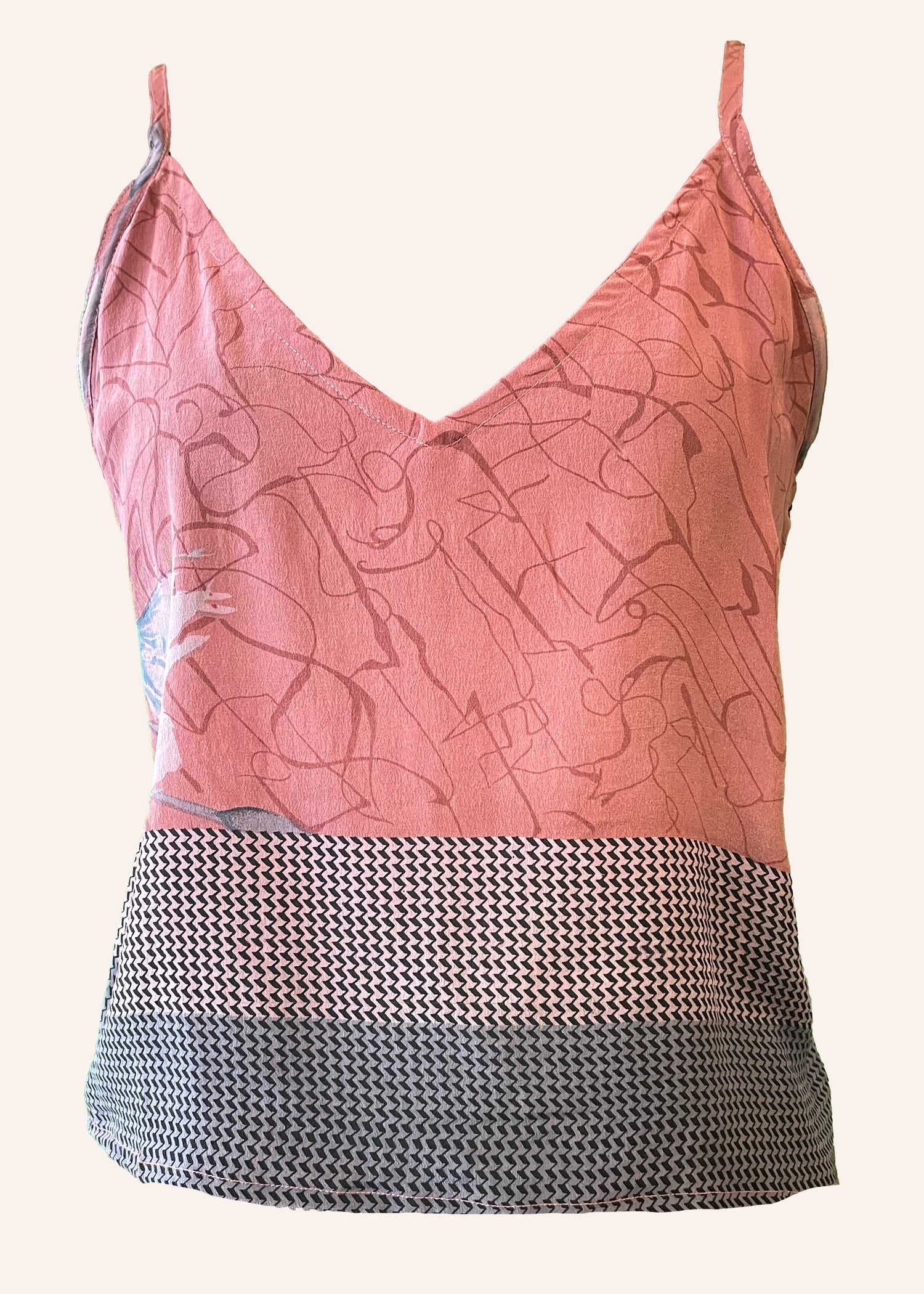 Pink patterned top with a black and white textured bottom on a white background
