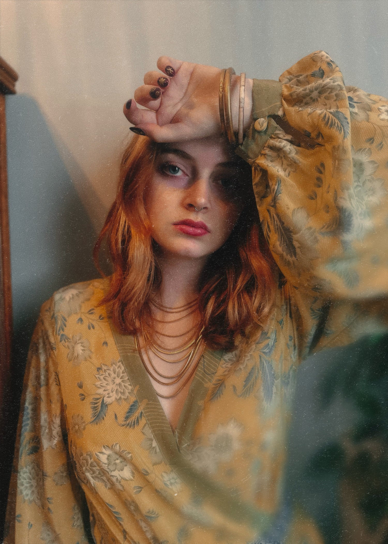 Woman wearing a bohemian style floral dress made from repurposed vintage Indian silk crepe sari with a neutral background