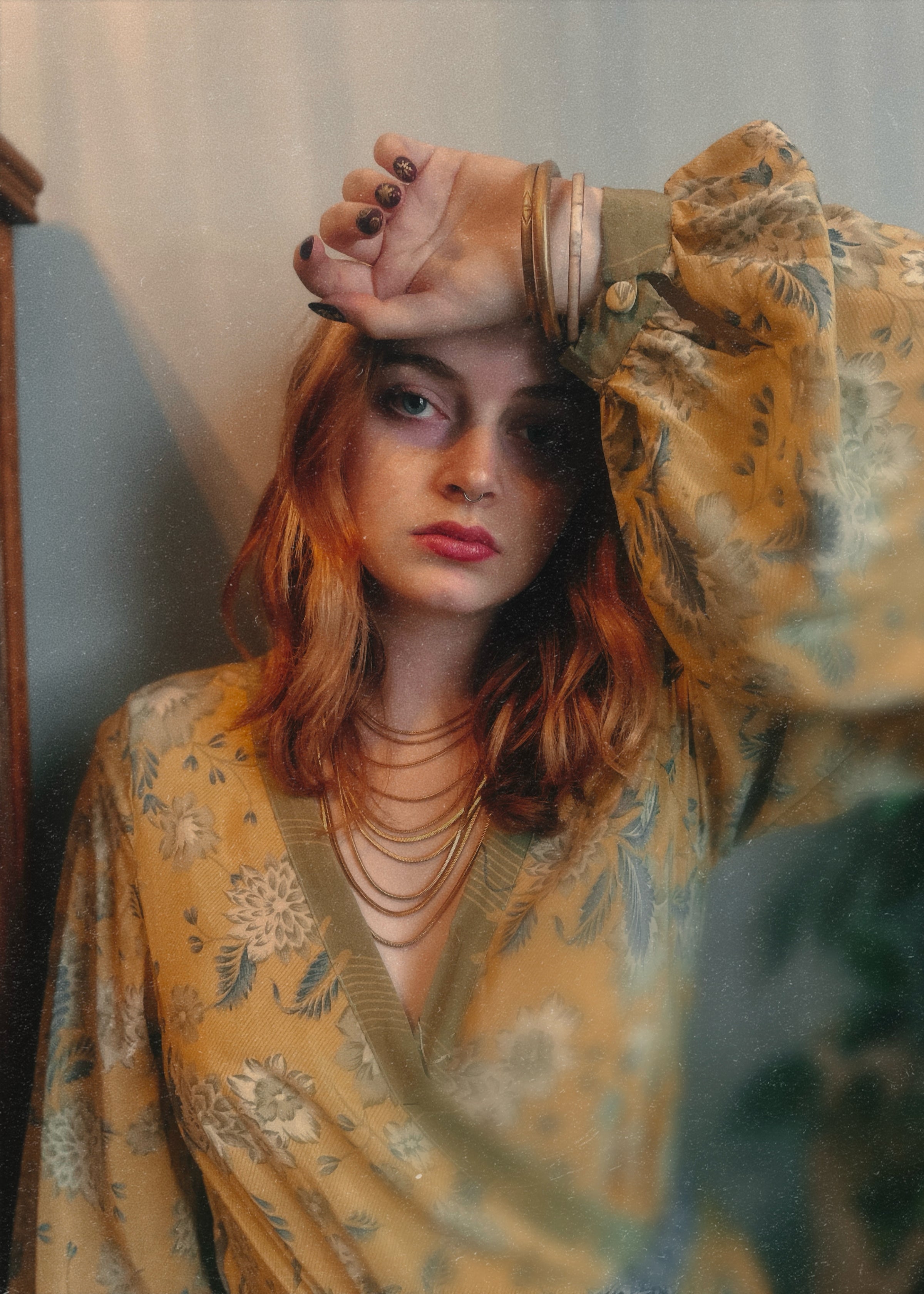 Woman wearing a bohemian style floral dress made from repurposed vintage Indian silk crepe sari with a neutral background